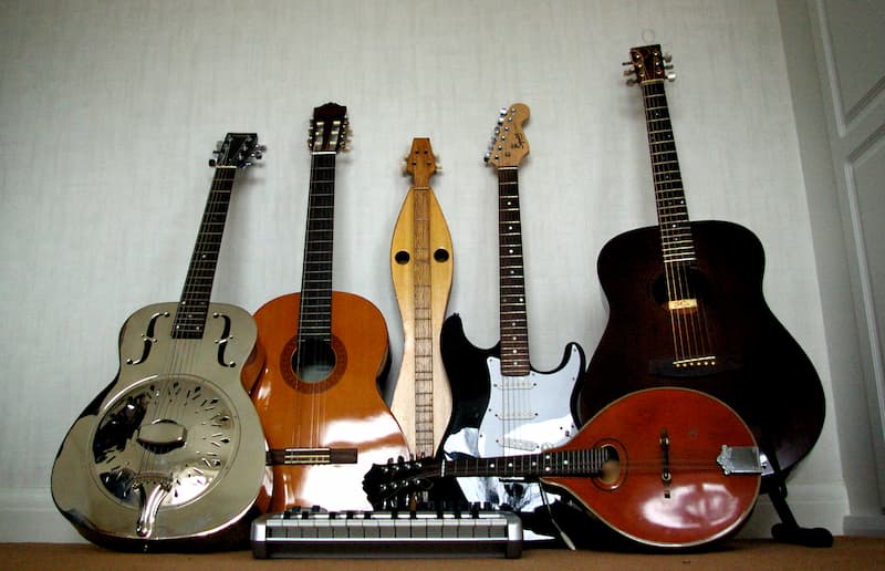 Assorted guitars and an electric keyboard.